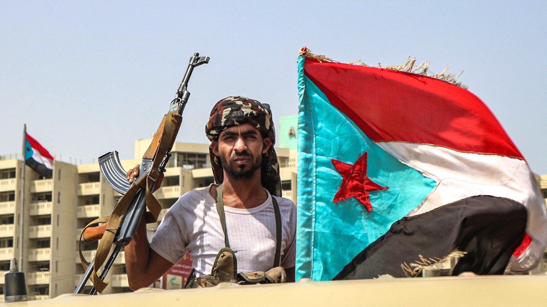 An STC fighter with the southern separatist flag (the old flag of South Yemen), in Aden in 2019 (AFP)