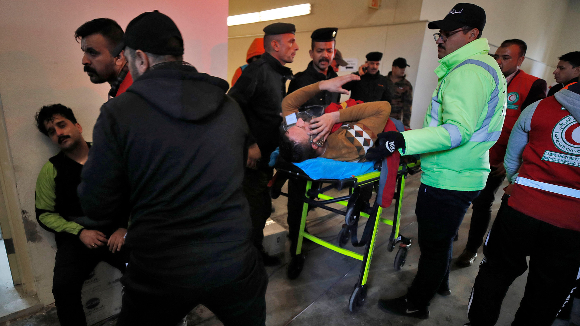 Injured football spectators are brought into an emergency area at the Basra International Stadium following a crush on 19 January 2023 (AFP)