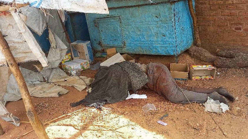 A covered body outside a house in el-Geneina, 16 June (AFP)
