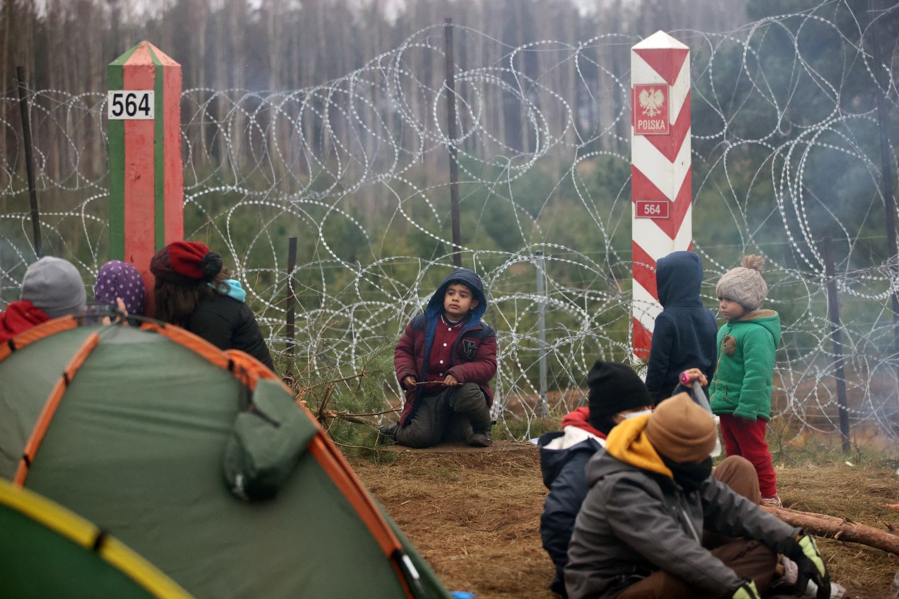 A picture taken on November 12, 2021 shows children in a migrants camp on the Belarusian-Polish border in the Grodno region (AFP)