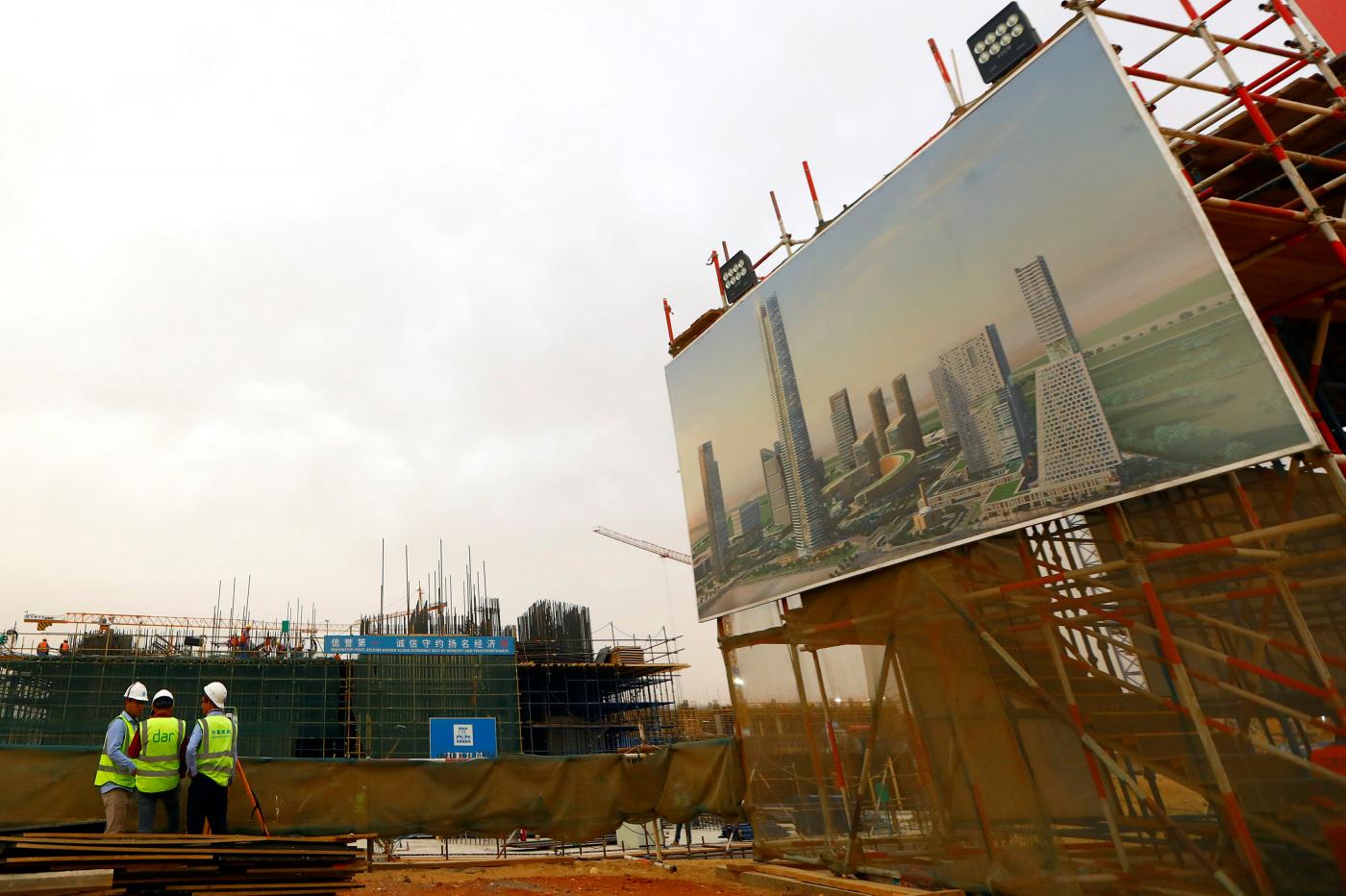 Chinese construction labourers work at the future "The Iconic Tower" east of Cairo (Reuters)