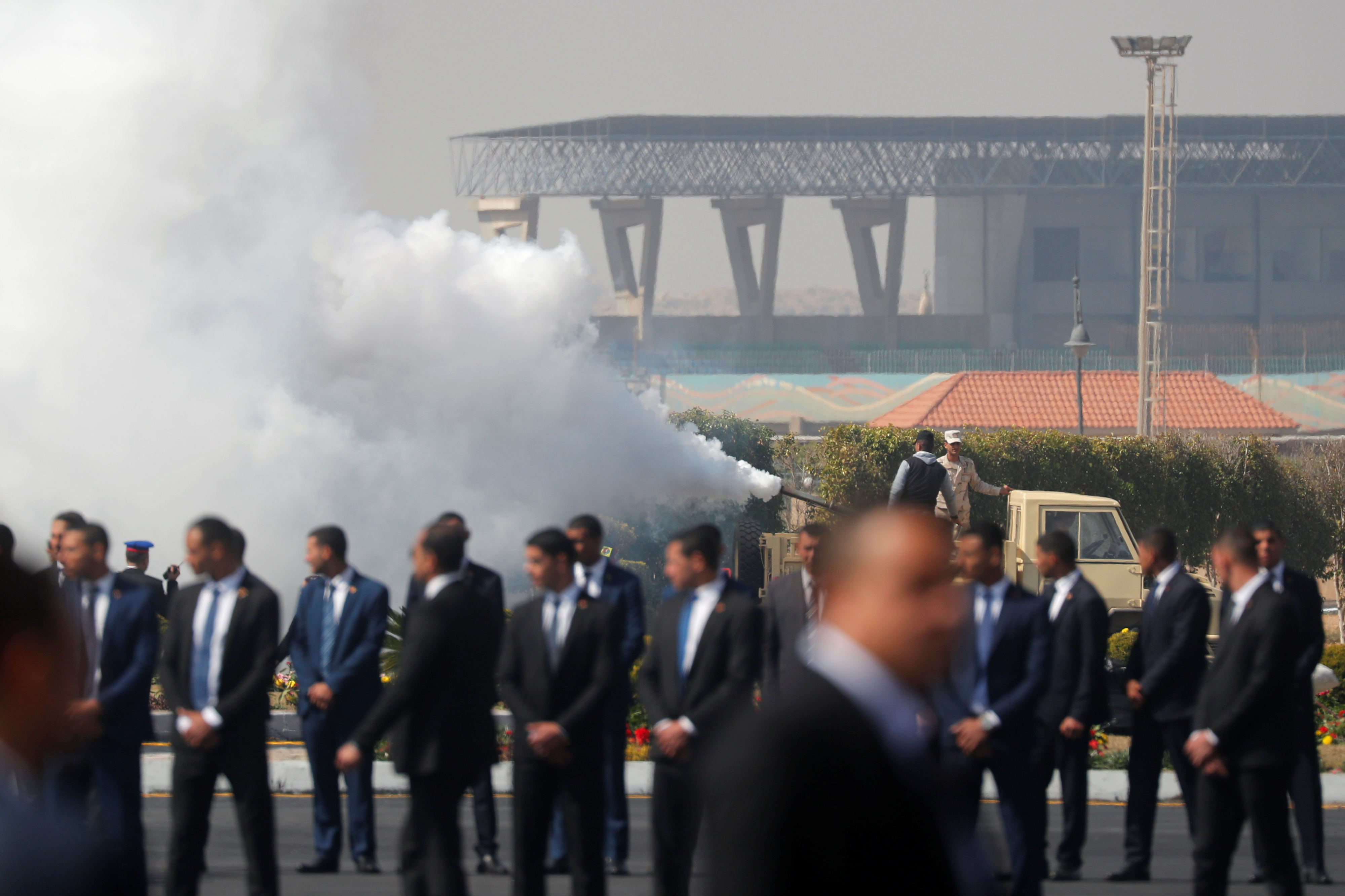 Members of Egyptian forces spray air freshener before the start of former Egyptian President Hosni Mubarak's funeral outside Field Marshal Mohammed Hussein Tantawi Mosque east of Cairo