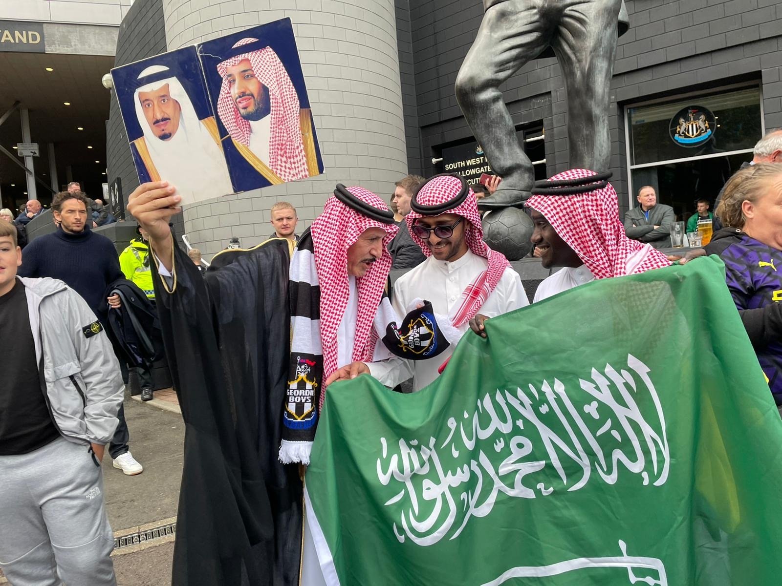 saudi journalist newcastle holds poster king salman mbs