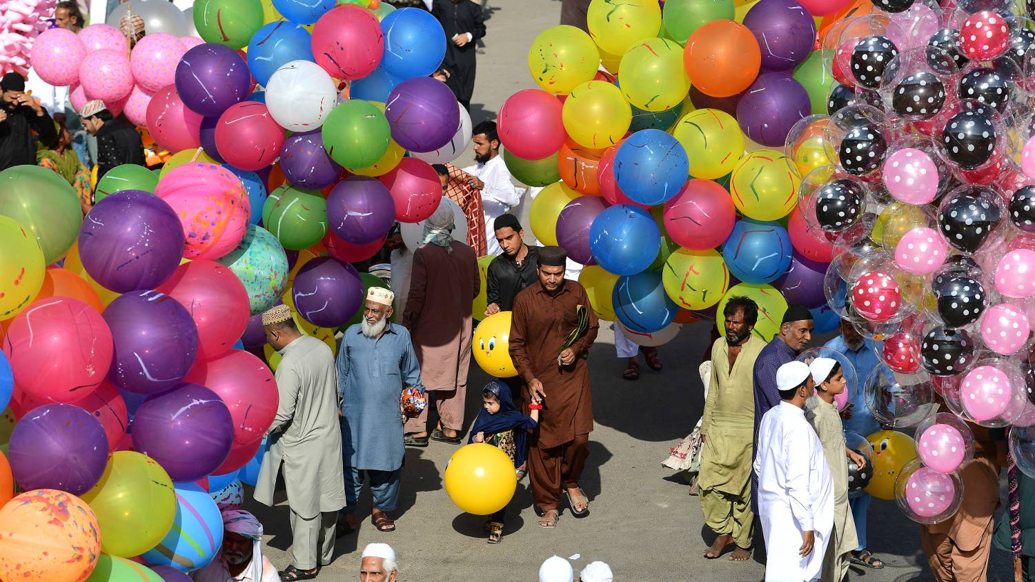 Street vendors sell colourful balloons in celebration of Eid in Karachi, Pakistan (Asif Hassan, AFP) 