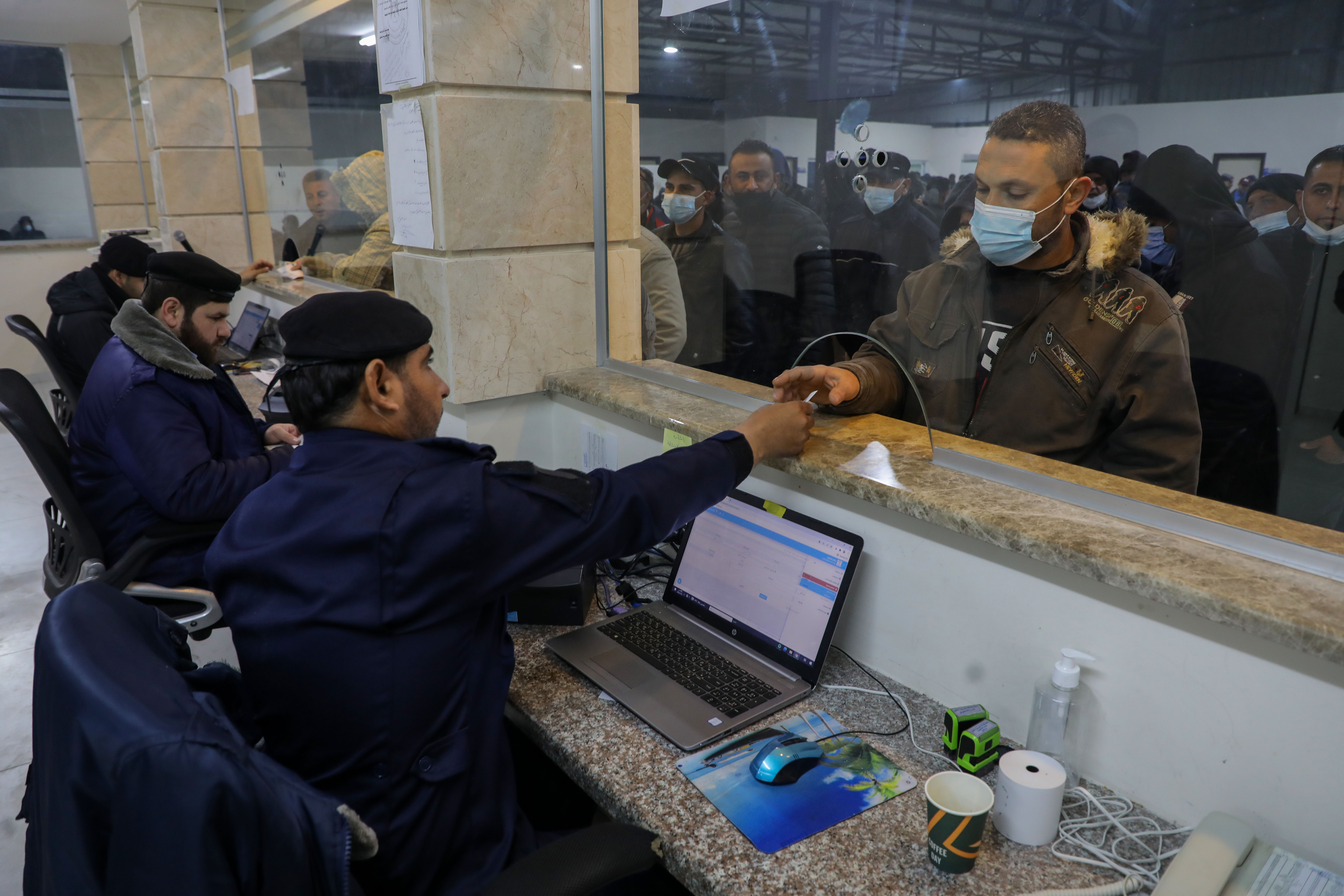 Guards check documents at the Erez border crossing