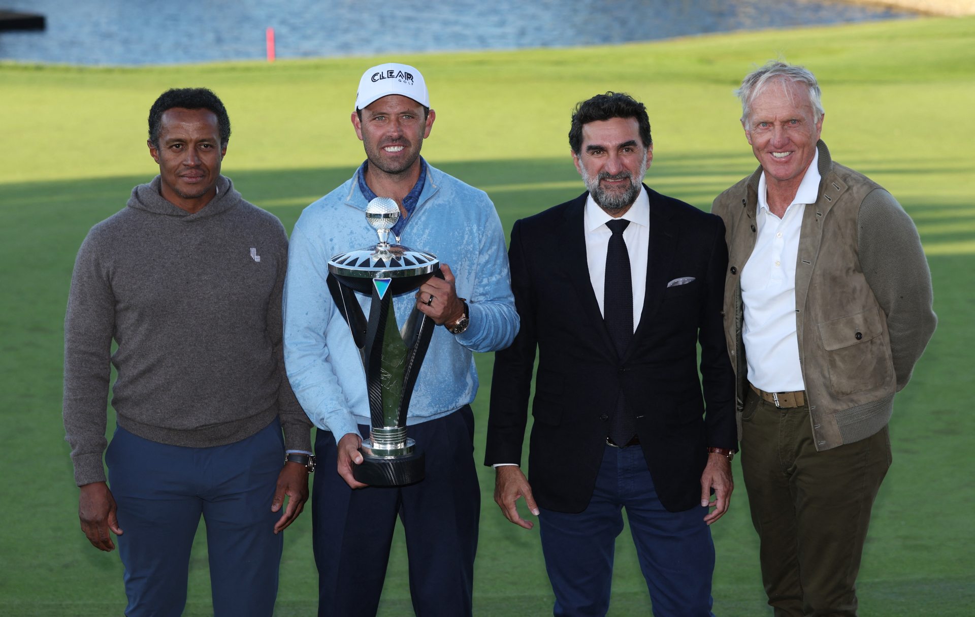 Winner Charl Schwartzel (holding trophy) poses with Saudi Golf Federation head Majed Al Sorour (L-R), PIF governor Yasir al-Rumayyan, and LIV Golf CEO Greg Norman (Reuters)
