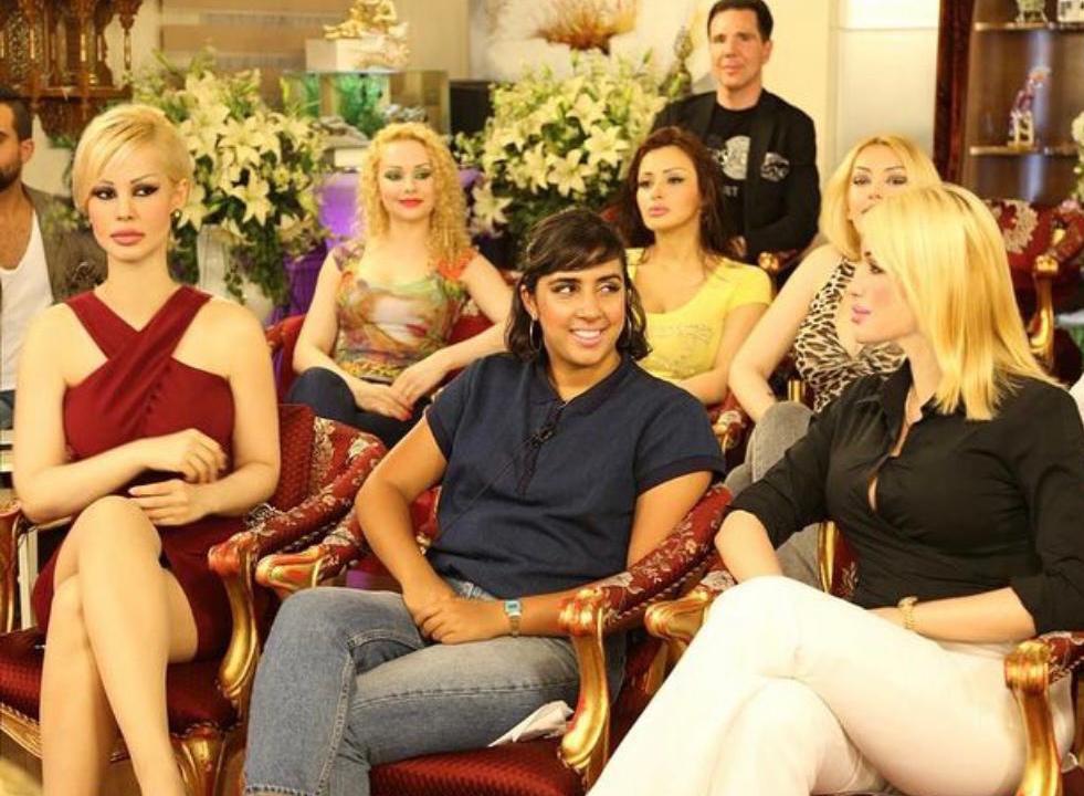 Meher Ahmad sitting with Adnan Oktar's 'kittens' on the set of his TV show (Meher Ahmad)