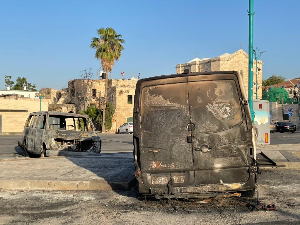 Burnt out vehicles from the previous nights' violence, 12 May, 2021. (MEE/Lubna Marsawa)