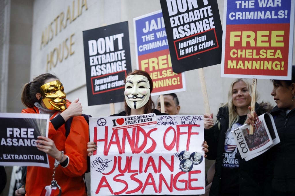 Protesters hold up placards as they gather outside Australia House to take part in a march in support of Wikileaks founder Julian Assange in London on February 22, 2020,