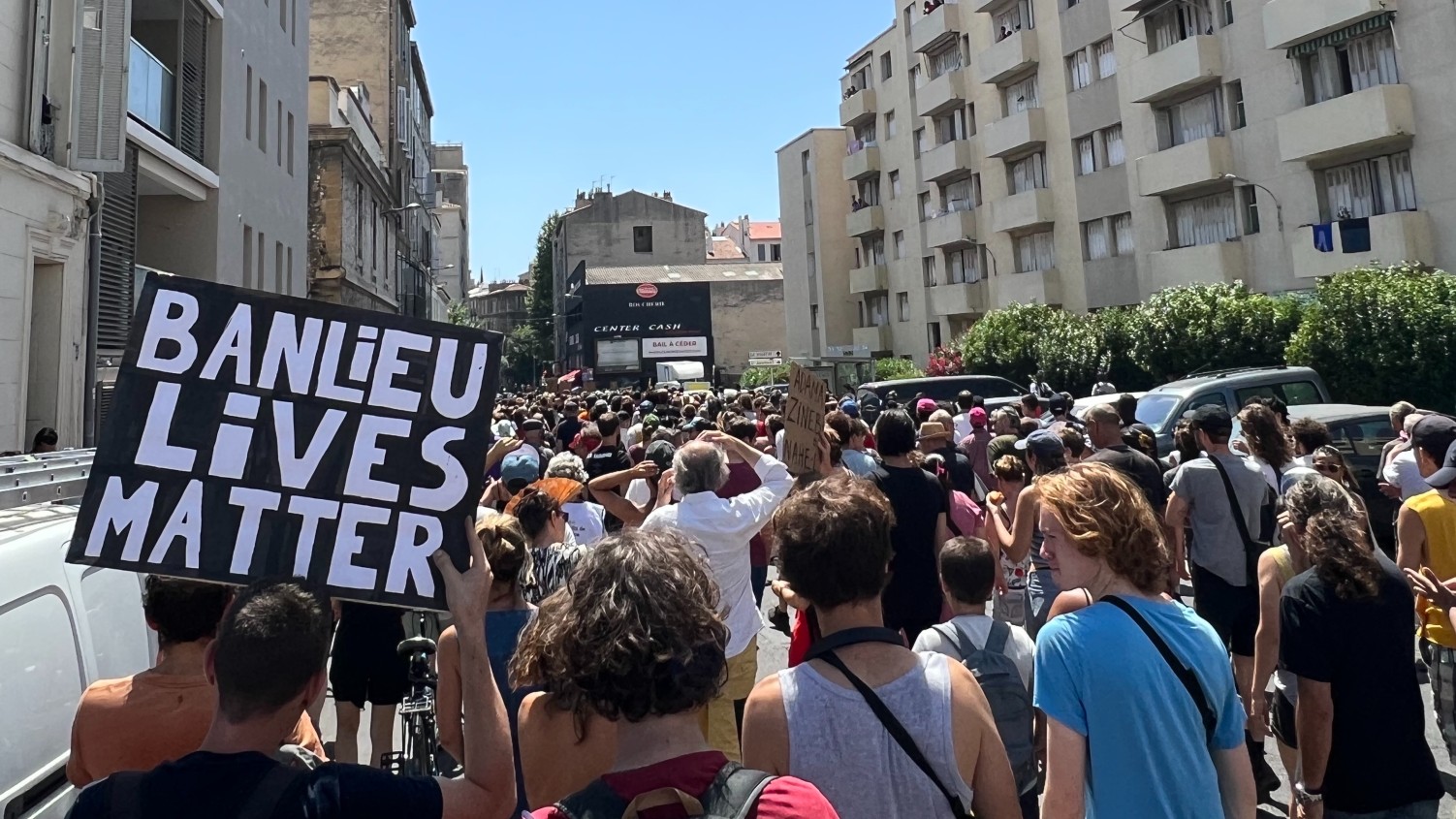 Protesters march in Marseille's Belle de Mai, one of the poorest areas in Europe, to demand justice in the suspected police killing of Mohamed B, on 8 July 2023 (MEE/Frank Andrews)