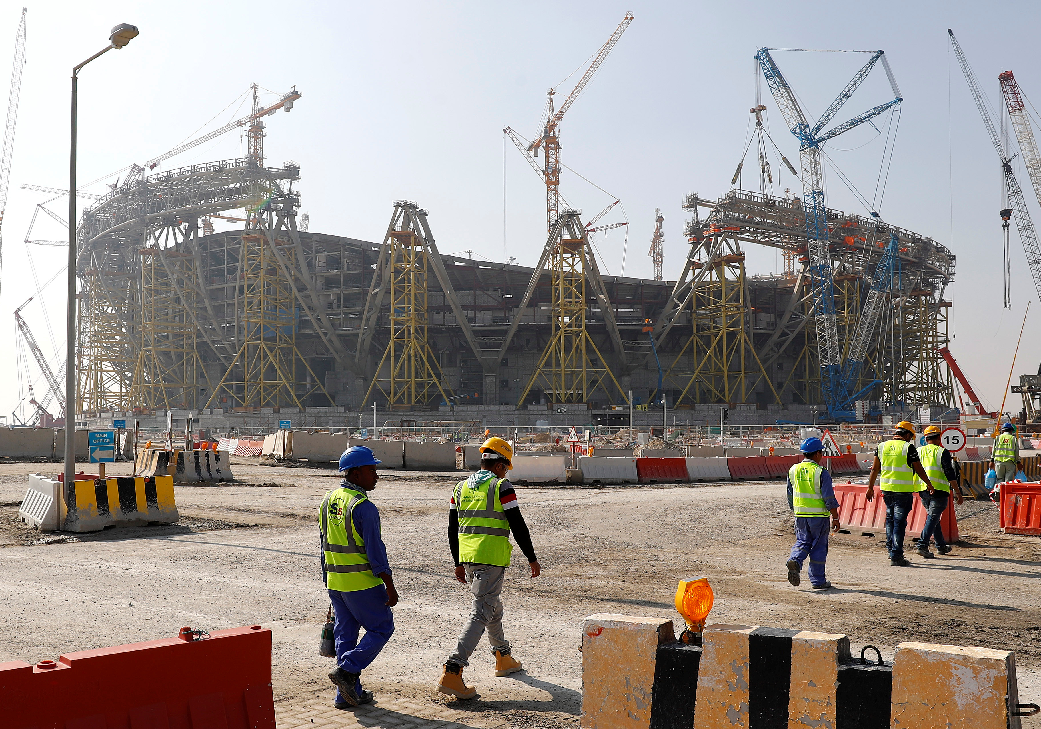 Workers in Qatar building a stadium ahead of the 2022 World Cup (Reuters)