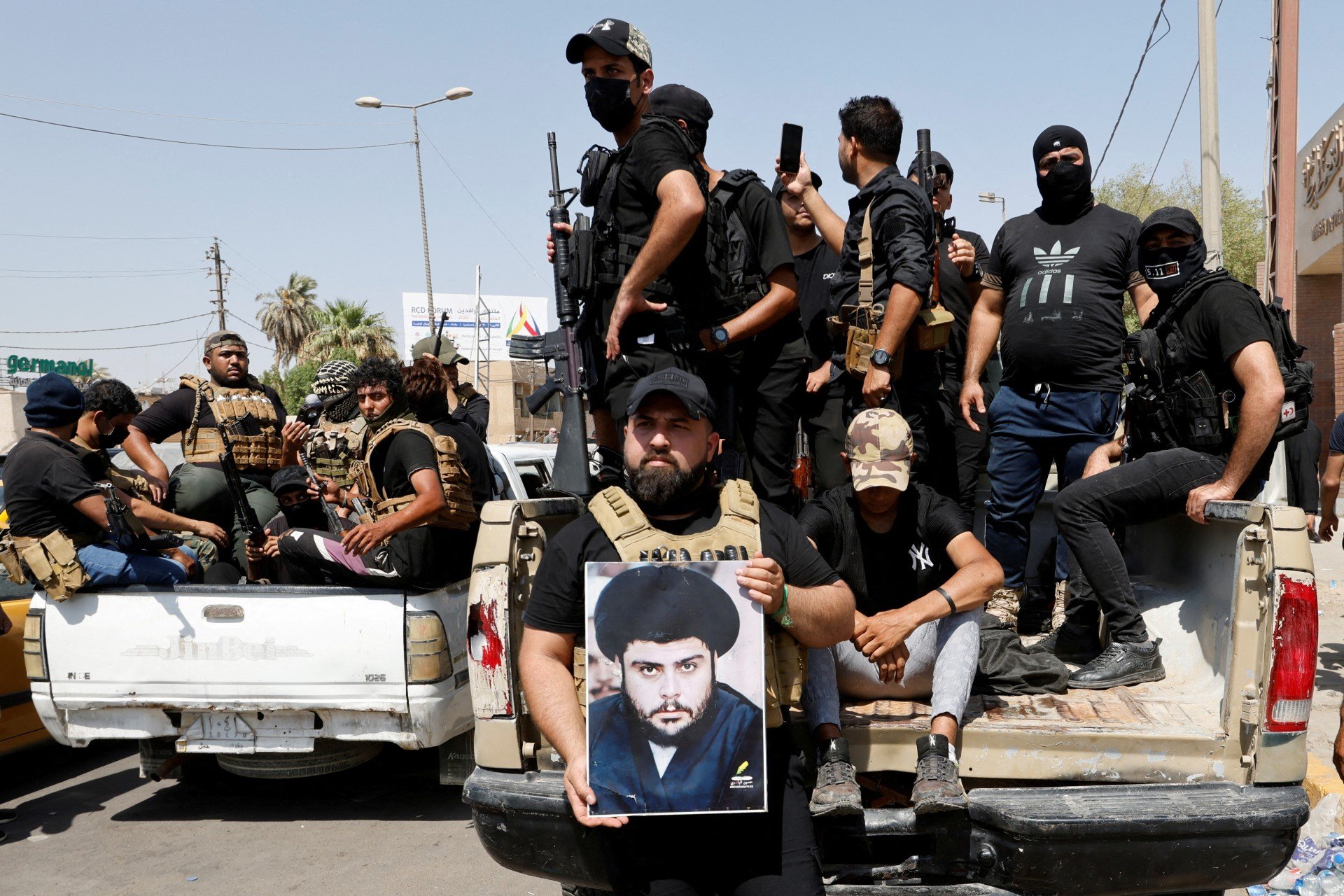 ​Followers of Muqtada al-Sadr withdraw from the streets after violent clashes, near the Green Zone in Baghdad, 30 August (Reuters) ​