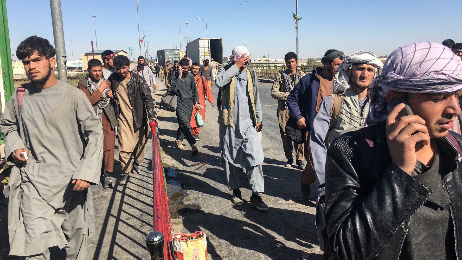 October 5, 2021, Afghan men try to leave the country walking towards the Afghan-Iran border in Zaranj in the southwestern province of Nimroz.