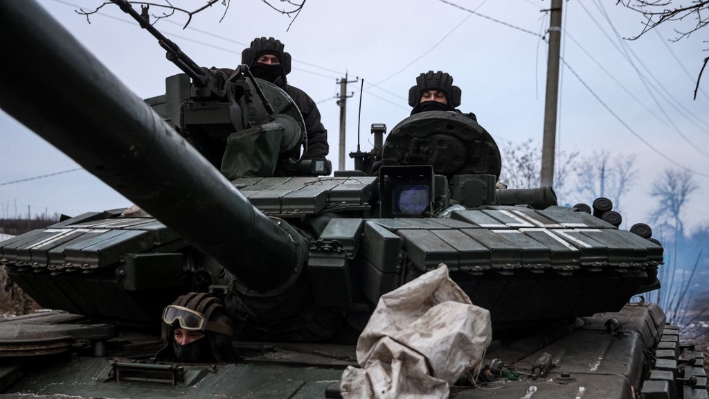 Ukrainian servicemen drive a tank in the Lugansk region on 12 January 2023 (AFP)