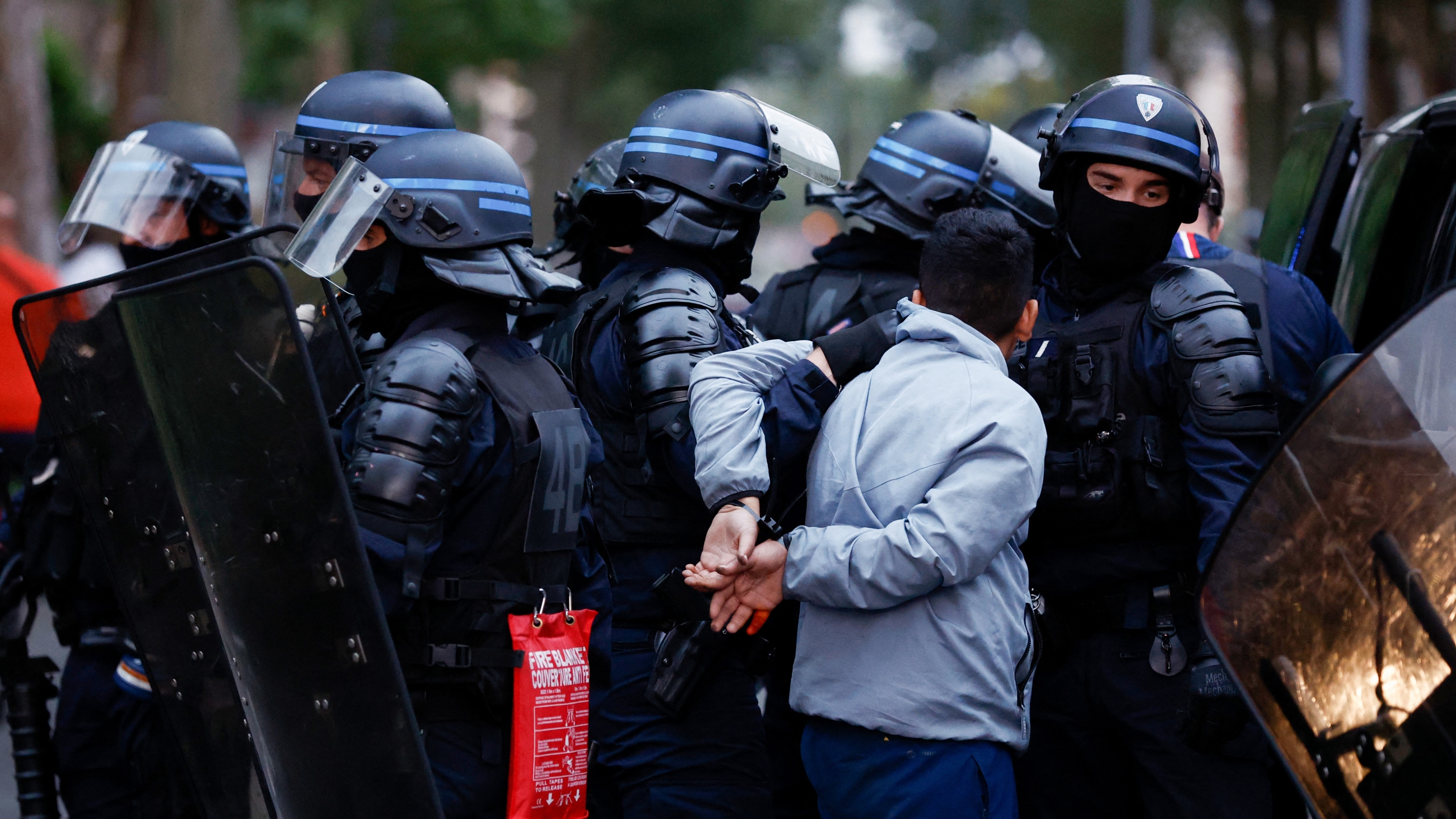 Police officers arrest a man during protests in Lille, northern France, two days after a teenager was shot dead by a police officer in the Paris suburb of Nanterre (AFP)