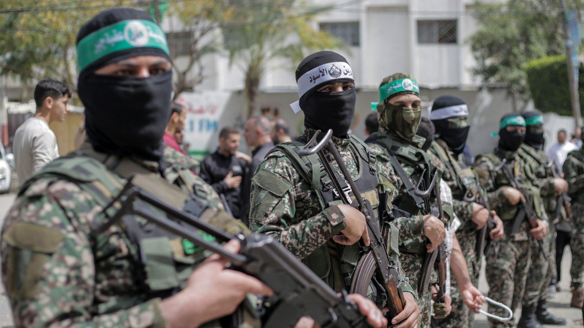 Masked members of the Hamas movement stand guard during a rally in solidarity with Jerusalem's Al-Aqsa Mosque, in Jabalia, in the northern Gaza Strip on 7 April (Reuters)