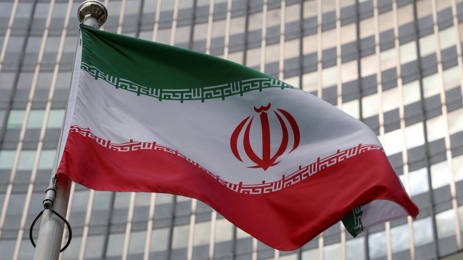 The Iranian flag flutters in front of the International Atomic Energy Agency (IAEA) headquarters in Vienna, 5 June (Reuters)