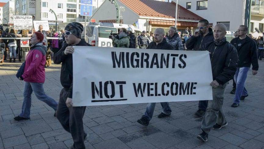 A protester holds a banner reading 'Migrants not welcome' during an anti-migrants rally in Tornio, Finland, 3 October 2015 (AFP)