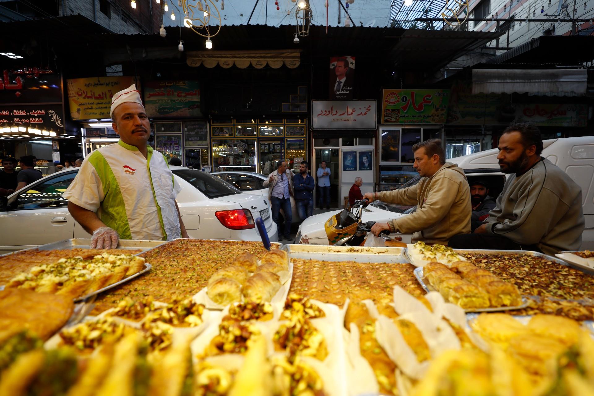 A Syrian sweet vendor in a Damascus souk (MEE)