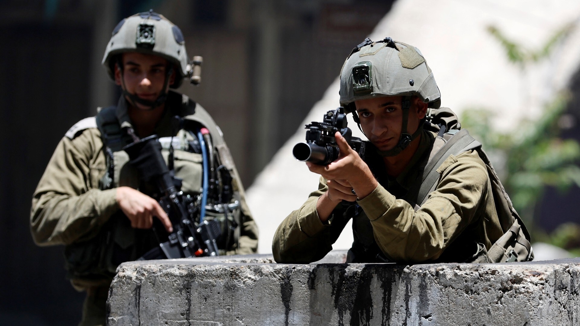 Israeli troops hold their positions during clashes with Palestinians over an Israeli military operation in Jenin, in Hebron, in the Israeli-occupied West Bank on 4 July 2023.
