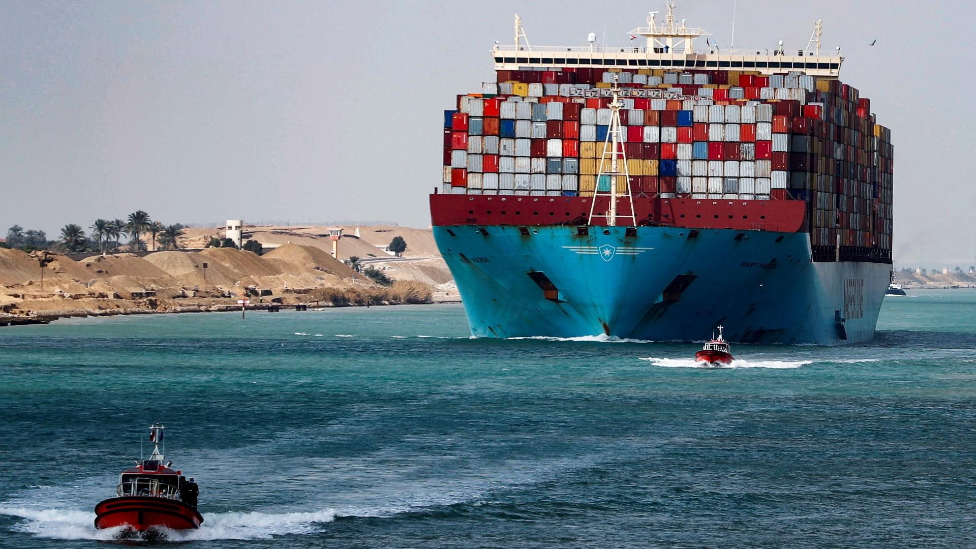 A shipping container passes through the Suez Canal in Suez, Egypt on 15 February 2022 (Reuters)