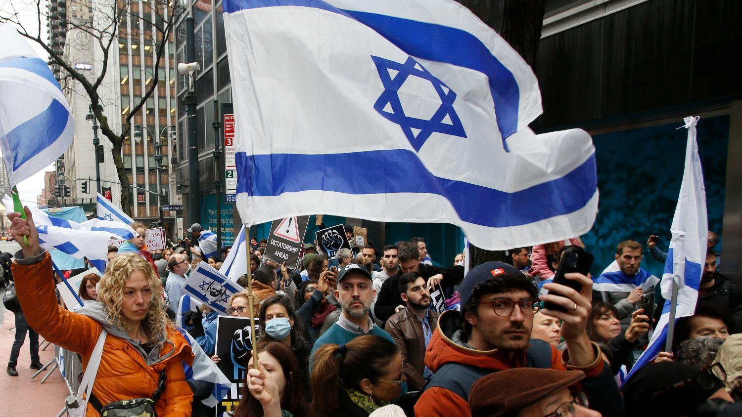 Members of the Israeli and Jewish community gather to protest outside the Israeli Consulate in New York on 27 March 2023 during an emergency rally for Israeli democracy.