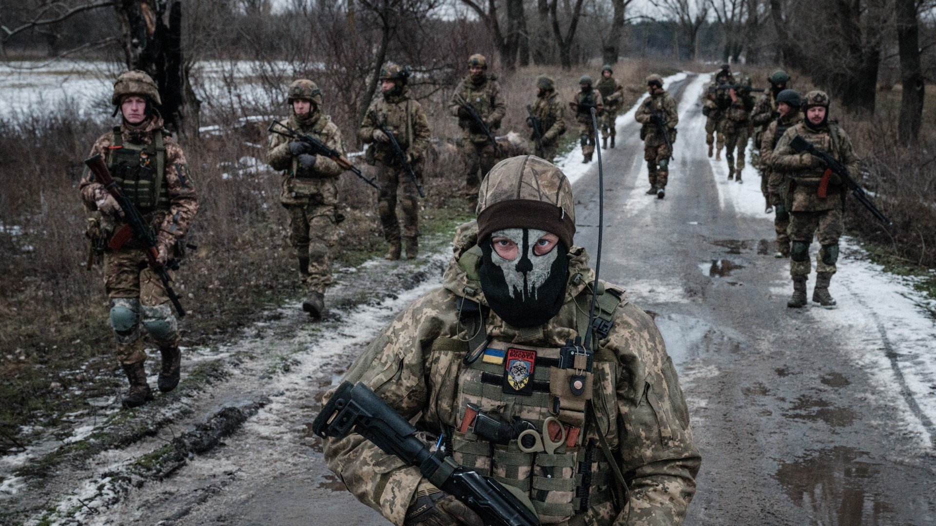 Ukrainian servicemen walk on the road toward their base near the frontline in the Donetsk region on February 4, 2023, amid the Russian invasion of Ukraine.