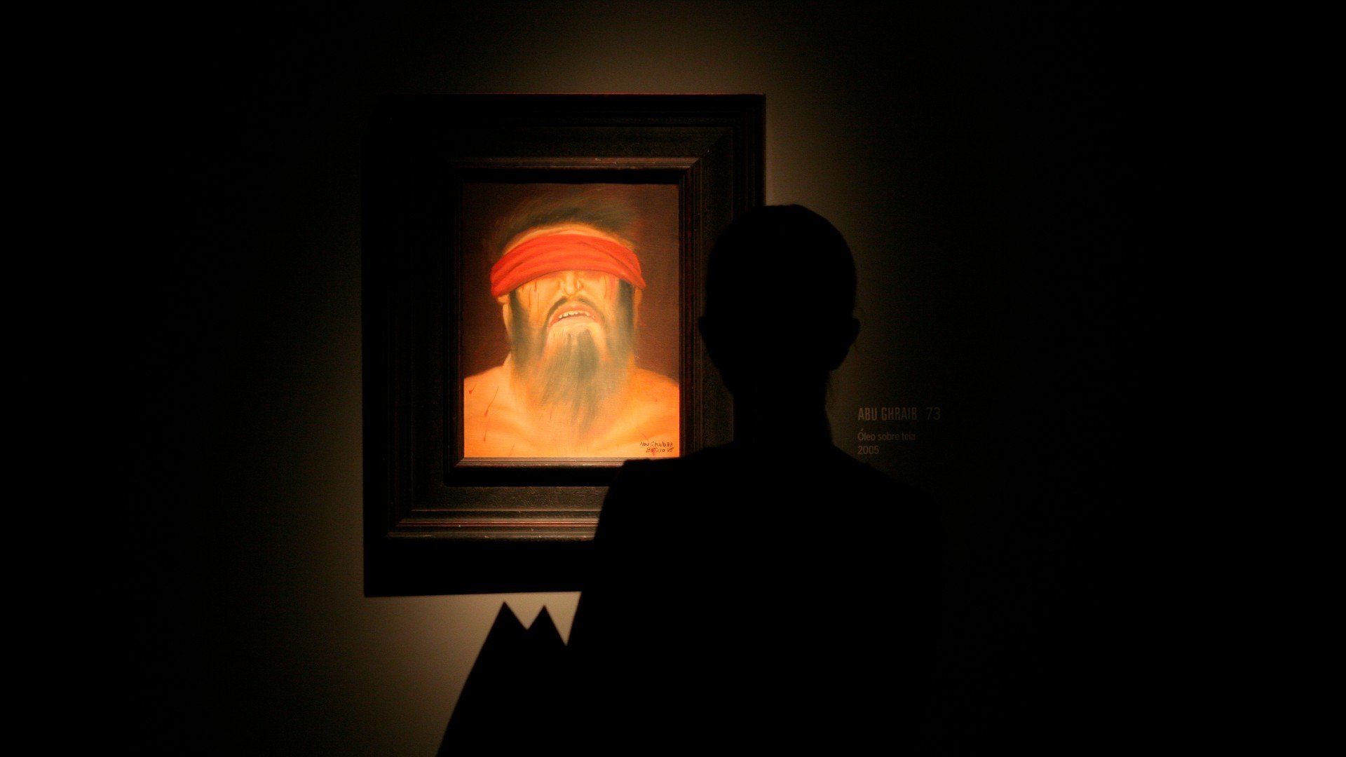 A visitor looks at a painting by Colombian artist Fernando Botero from his Abu Ghraib collection at the Arts Center in the northern city of Monterrey February 7, 2008